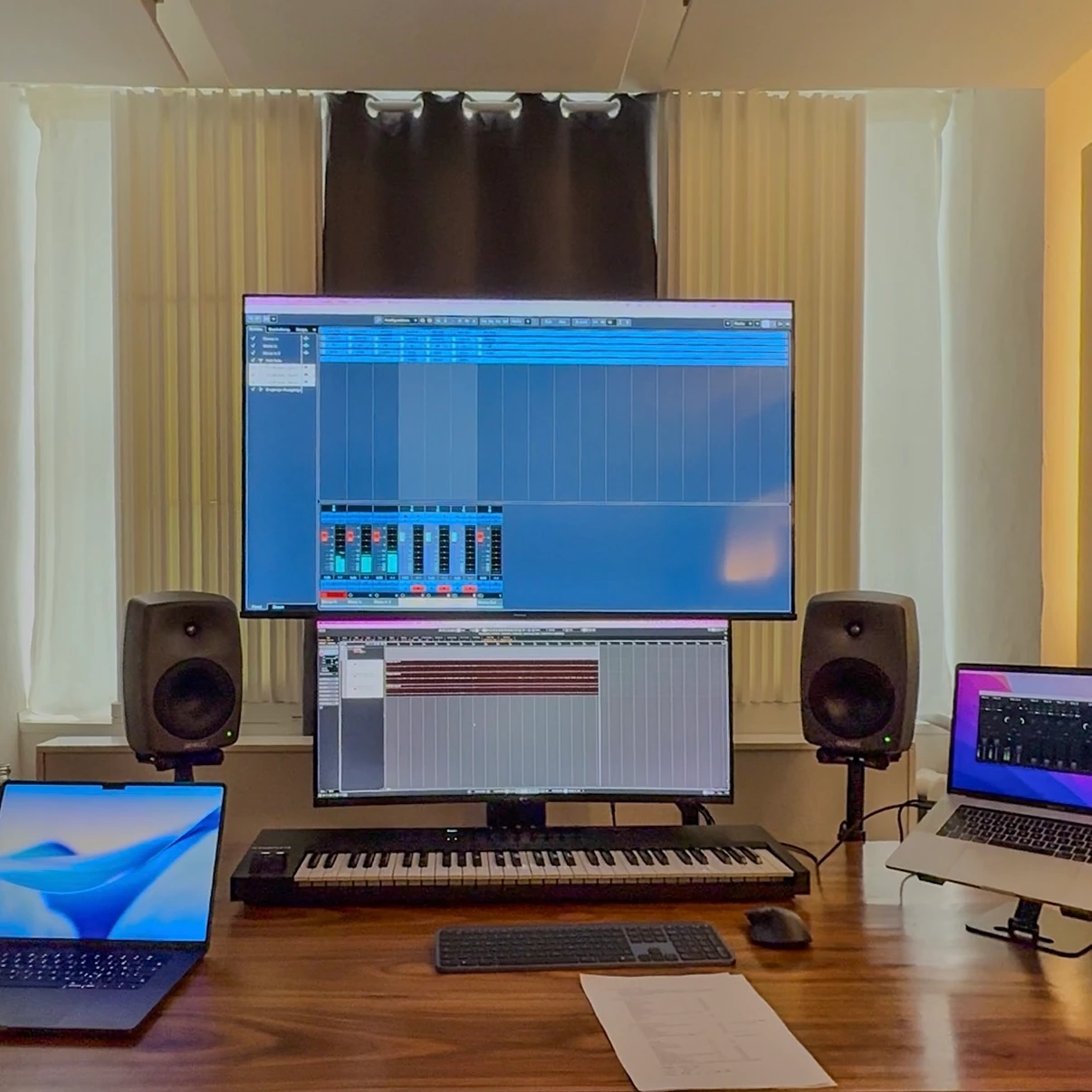 Control room workstation — studio monitors, MIDI keyboard, and dual screens